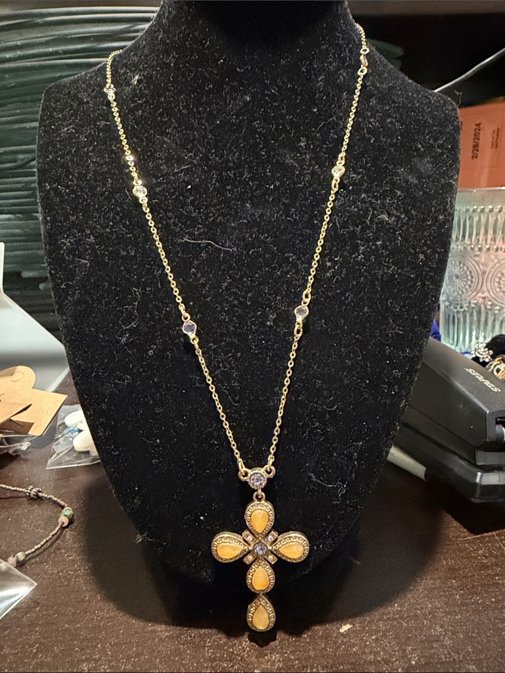 Vintage Avon gold-tone necklace featuring a jeweled cross pendant